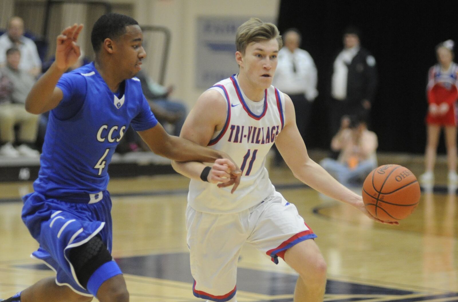 Cincinnati Christian’s Dylan Woods (left) defends Gavin Richards of New Madison Tri-Village on March 14 during a Division IV regional semifinal at Fairmont’s Trent Arena. MARC PENDLETON/STAFF