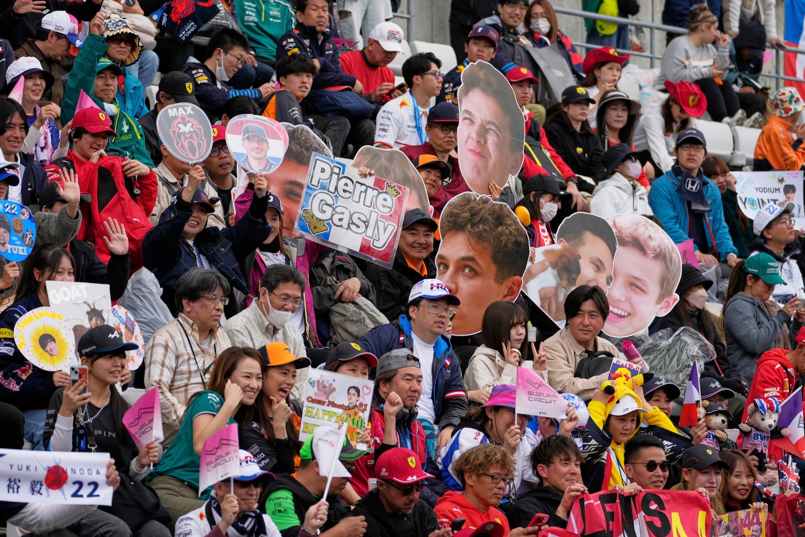 Fans cheer before the Japanese Formula One Grand Prix race at the Suzuka Circuit in Suzuka, central Japan, Sunday, April 6, 2025. (AP Photo/Shuji Kajiyama)