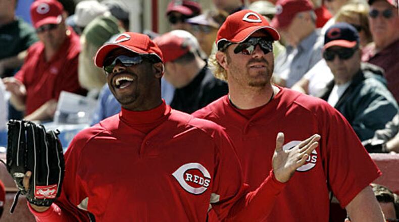 Friday, Feb. 29, 2008 Cincinnati Reds outfielders Ken Griffey Jr., left, and Adam Dunn wait to go onto the field during a spring training baseball game against the Tampa Bay Rays in Sarasota, Fla.