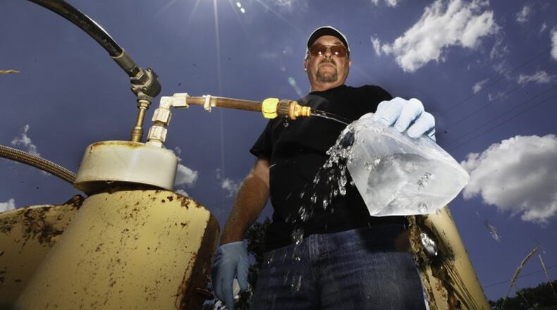 Dan Day, a water lab technician with the City of Dayton, takes a sample from one of 200 monitoring wells used to check on the quality of water in the Great Miami Buried Valley Aquifer and test for any contaminants on a regular basis. CHRIS STEWART / STAFF