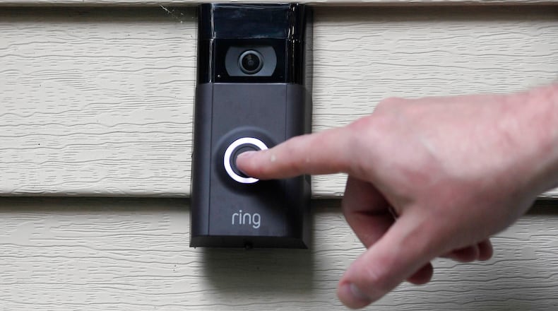 FILE - A person pushes the doorbell on their Ring doorbell camera, July 16, 2019, in Wolcott, Conn. (AP Photo/Jessica Hill, File)