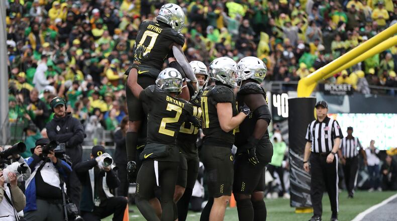 Oregon running back Bucky Irving (0) celebrates with teammates after scoring a touchdown against California during the second half of an NCAA football game, Saturday, Nov. 4, 2023, in Eugene, Ore. (AP Photo/Amanda Loman)