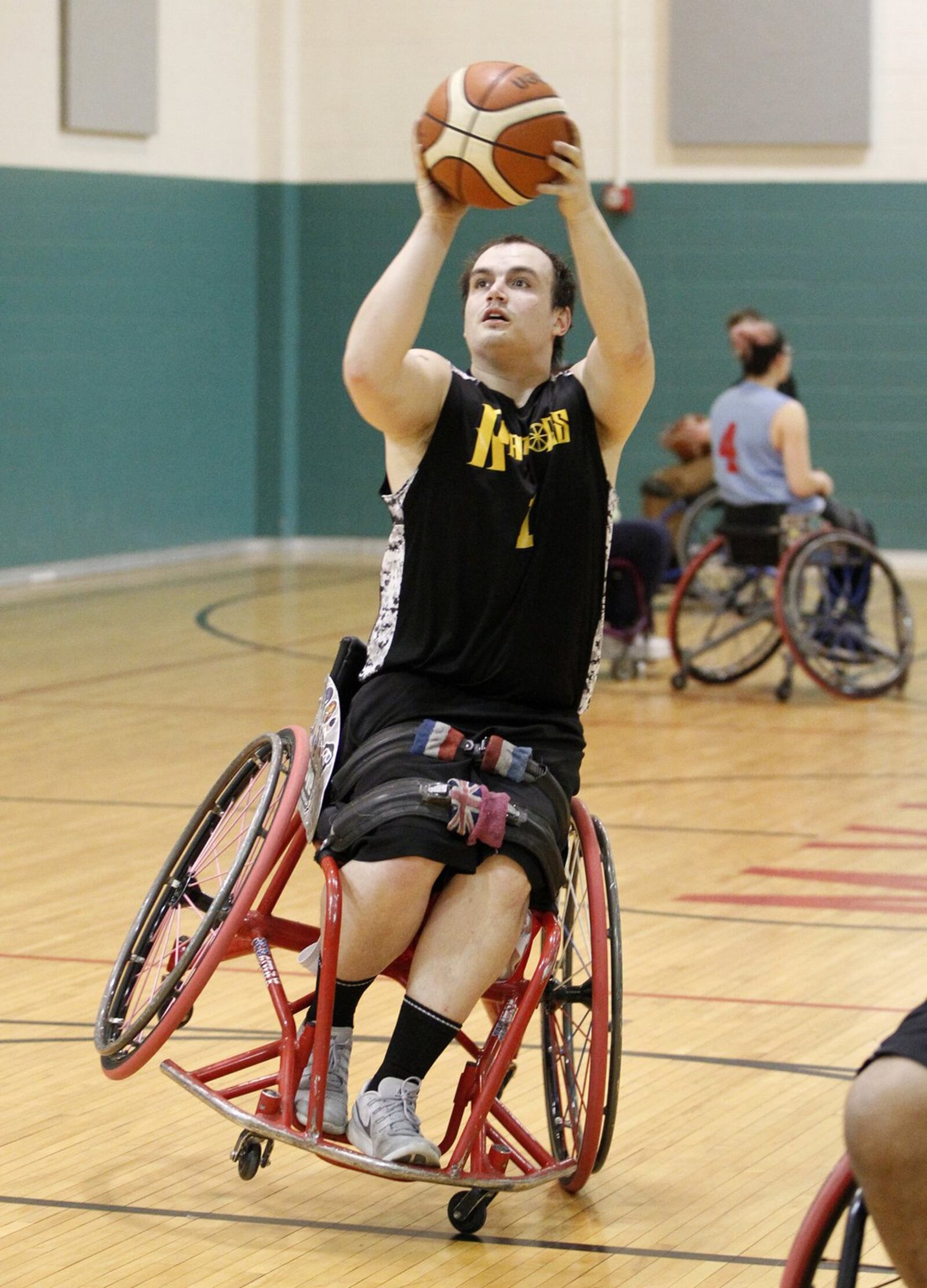 Zach Blair of Fairborn shoots during practice with the Miami Valley Raptors wheelchair basketball team. LISA POWELL / STAFF