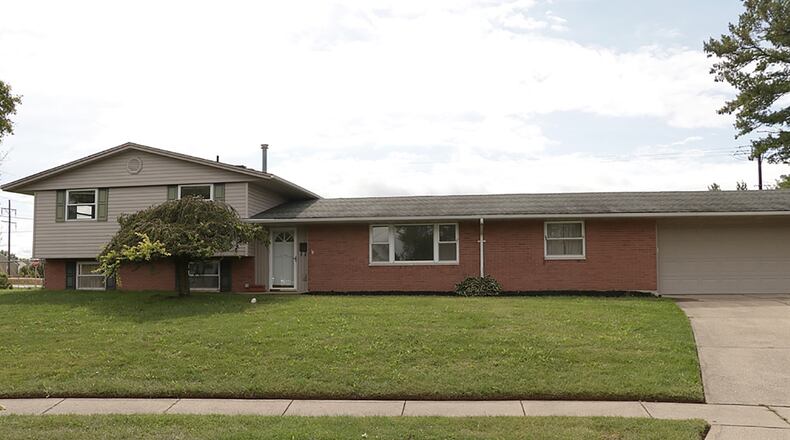 The brick-and-frame tri-level has about 2,260 square feet of living space with 3 bedrooms. The house sits off a circular bend of two streets with a roadway island out front. The tri-level has a bonus area between the dining room and 2-car garage that could be a workshop, garden room or finished into additional living space. CONTRIBUTED PHOTO BY KATHY TYLER