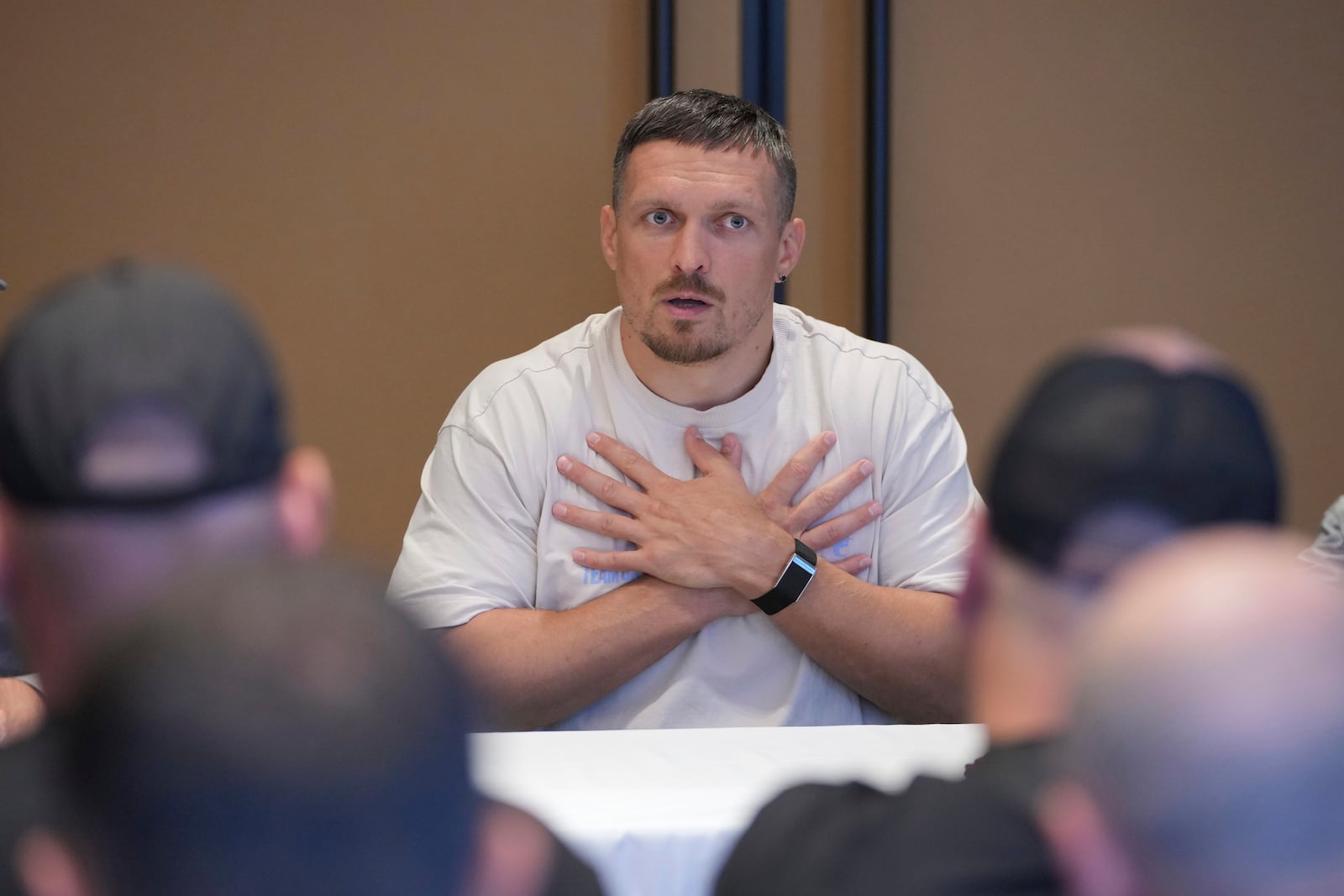 Ukraine's boxer Oleksandr Usyk speaks as he meets the Ukrainian war veterans, who are employees of Ukrainian power company DTEK at a hotel in Battersea Park in London, Thursday, July 17, 2025 ahead of the undisputed heavyweight champion boxing fight between Britain's Daniel Dubois and Oleksandr Usyk on Saturday. (AP Photo/Kin Cheung)