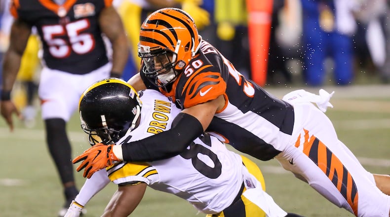 Cincinnati Bengals linebacker Jordan Evans defends a pass against Pittsburgh Steelers wide receiver Antonio Brown on Monday night. GREG LYNCH/STAFF PHOTO