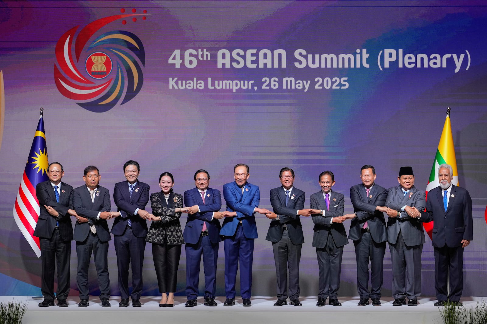 ASEAB leaders chain their hands while posing for a picture before the start of the plenary session at the Association of Southeast Asian Nations (ASEAN) Summit in Kuala Lumpur, Malaysia, Monday, May 26, 2025. From left to right, Laos's Prime Minister Sonexay Siphandone, Myanmar Permanent Secretary of the Ministry of Foreign Affairs Aung Kyaw Moe, Singapore's Prime Minister Lawrence Wong, Thailand's Prime Minister Paetongtarn Shinawatra, Vietnam's Prime Minister Pham Minh Chinh, Malaysia's Prime Minister Anwar Ibrahim, Philippine's President Ferdinand Marcos Jr., Brunei's Sultan Hassanal Bolkiah, Cambodian Prime Minister Hun Manet, Indonesia's President Prabowo Subianto and East Timor's Prime Minister Xanana Gusmao. (AP Photo/Vincent Thian)