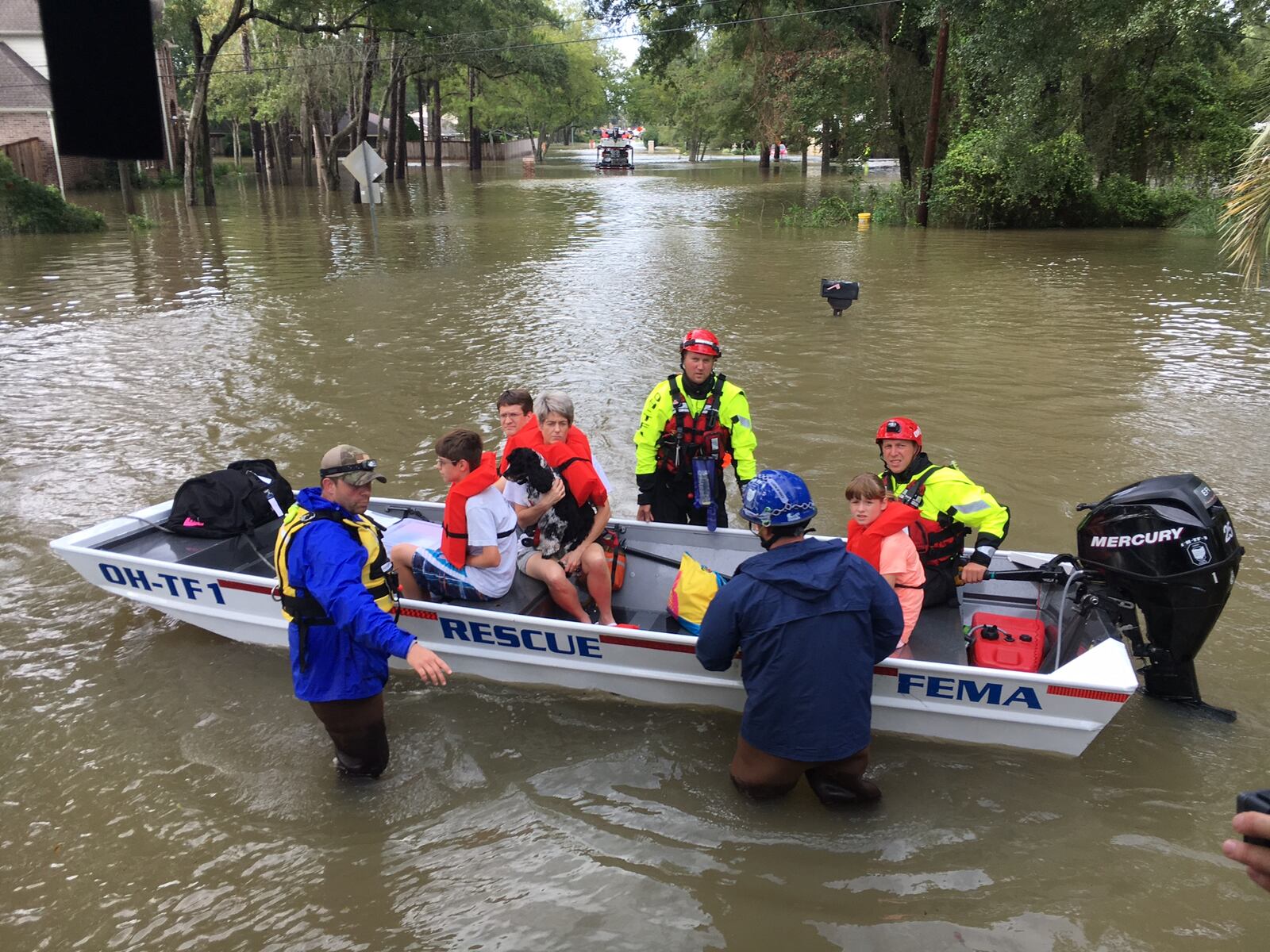 Members of Ohio Task Force 1 help residents and pets living on Dairy Ashford Road in Houston’s west side onto boats Tuesday afternoon. Chuck Hamlin/Staff