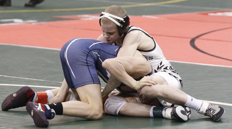 Eli Stickley of St. Paris Graham wrestles Seth Beard of Napoleon at 106 lbs. during the semi-final round of the Ohio high school wrestling championships at the Jerome Schottenstein Center in Columbus on Friday, March 1, 2013. Barbara J. Perenic/Staff
