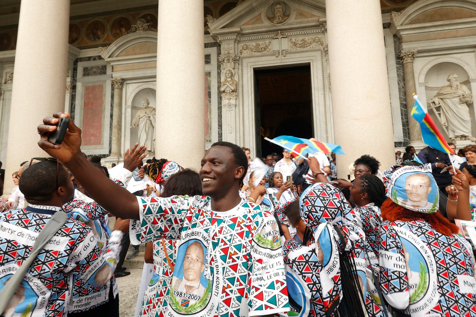 Faithful celebrate at the end of a ceremony for the beatification of Floribert Bwana Chui Bin Kositi, a Congolese man killed in 2007 for fighting corruption, in St. Paul Outside the Walls' Basilica, in Rome, Sunday, June 15, 2025. (AP Photo/Riccardo De Luca)