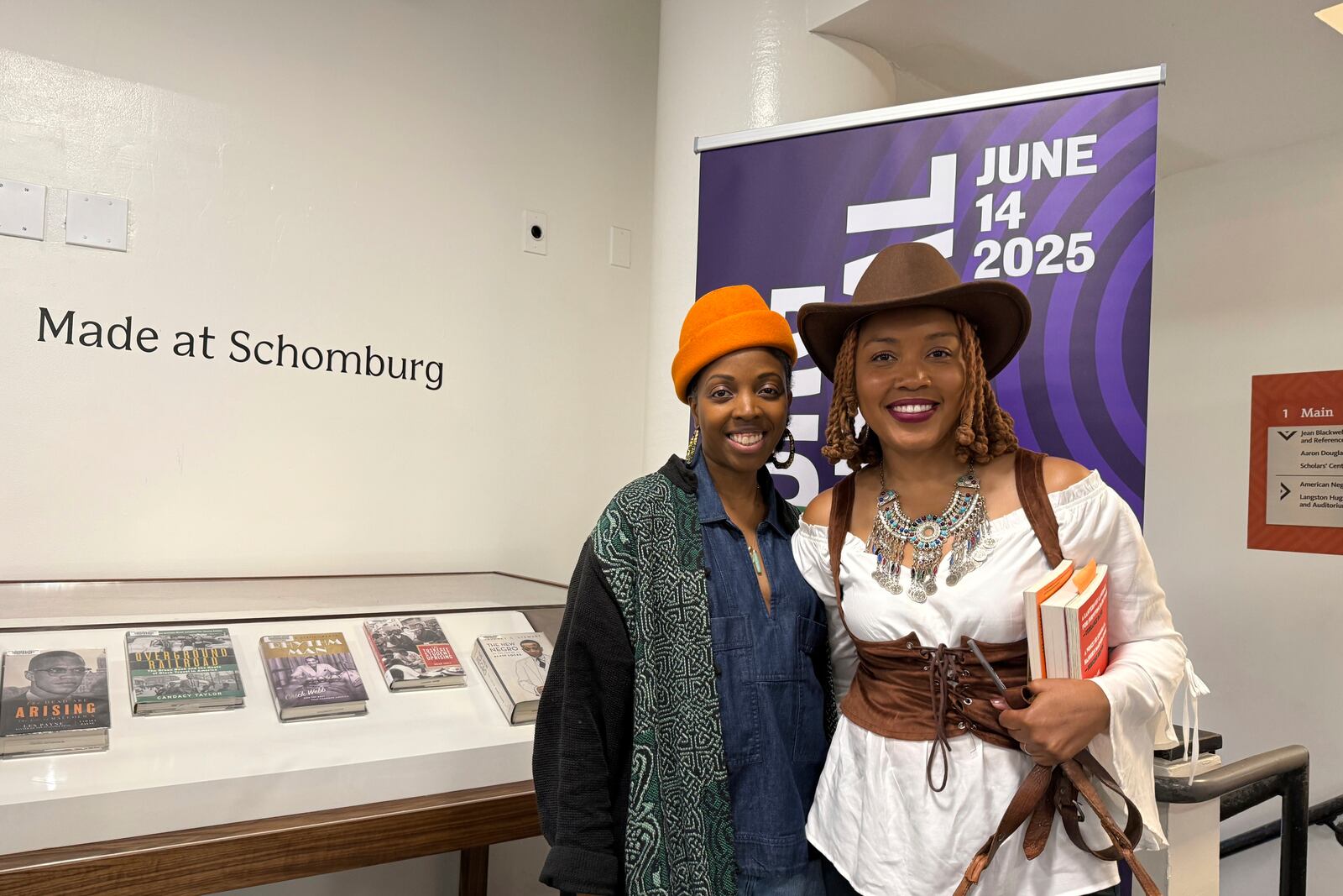 Novella Ford associate director of public programs and exhibitions (left) and Subha Ahmed, poet and one of the lead instructors of the junior scholars (right) inside the Schomburg Center for Research in Black Culture in New York on Saturday, June 14, 2025. (AP Photo/Jaylen Green)