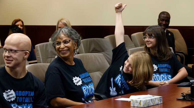 When asked is she's ready for her new family, Ruth Dameron gives a big thumbs up to a crowded courtroom Friday morning, Nov. 1, 2024. Her siblings, Ava and Ryan, were adopted by Carla Dameron. MARSHALL GORBY\STAFF
