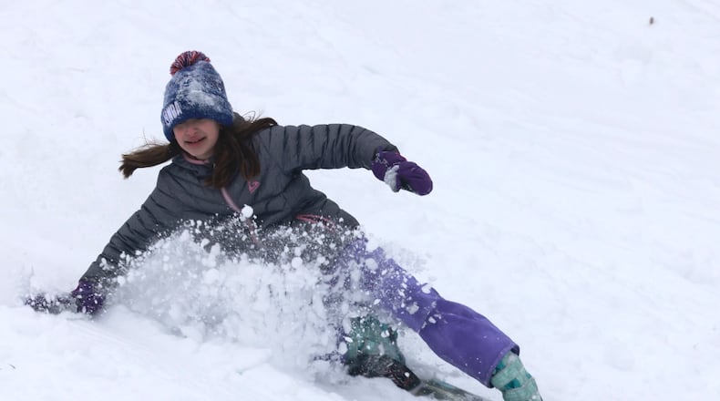 Instead of going back to school Monday, Jan. 6, 2025 a group of kids were having fun sledding at Bomberger Park in Dayton. BILL LACKEY/STAFF
