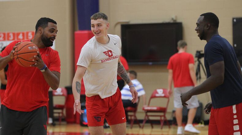 Dayton’s Ricardo Greer, Chase Johnson and Khyle Marshall warm up before a team workout on Monday, Sept. 23, 2019, at the Cronin Center. David Jablonski/Staff