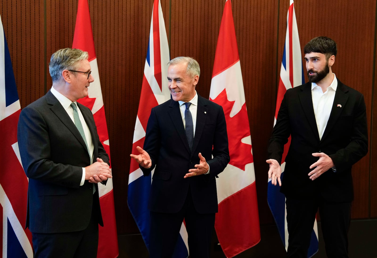 Prime Minister of Canada Mark Carney, centre, and Prime Minister of the United Kingdom Keir Starmer, left, meet with Aidan Gomez, CEO of AI startup Cohere, in Ottawa on Sunday, June 15, 2025. (Justin Tang/The Canadian Press via AP)