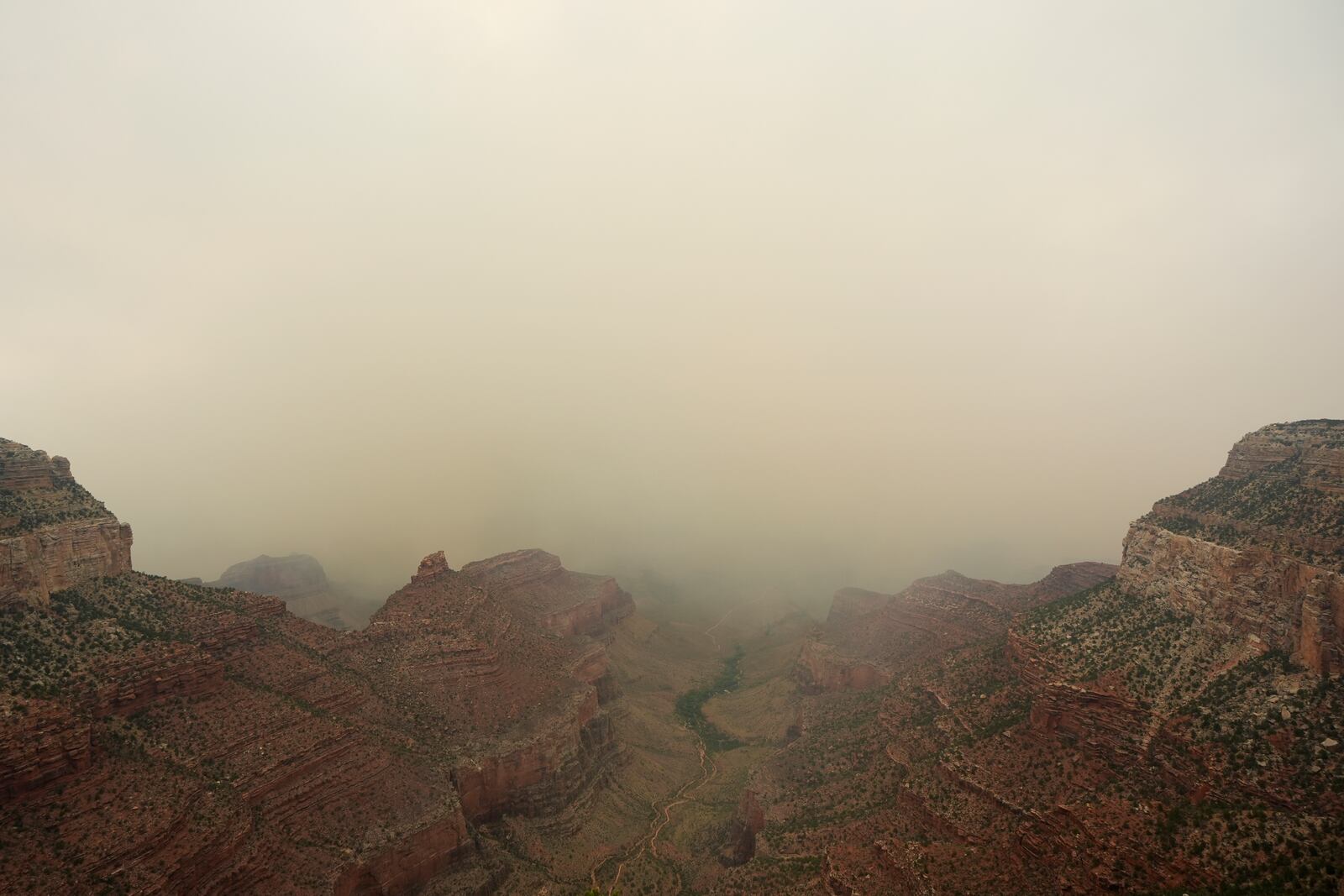 Smoke from the Dragon Bravo Fire moves over the Grand Canyon from the North Rim, Monday, July 14, 2025, in Grand Canyon National Park, Ariz. (AP Photo/Ross D. Franklin)
