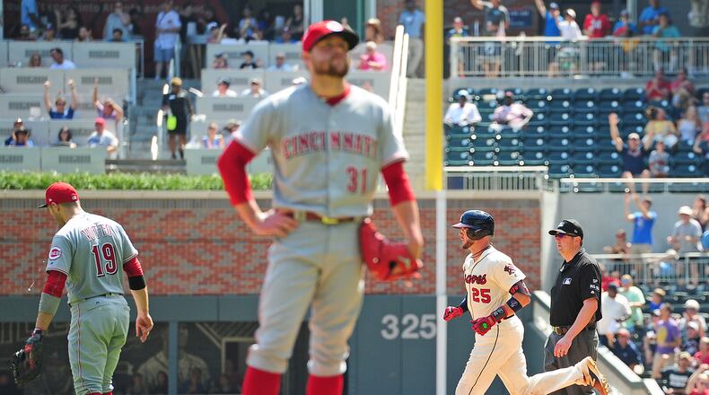 ATLANTA, GA - AUGUST 20: Tyler Flowers #25 of the Atlanta Braves rounds the bases after hitting a fifth inning grand slam as Drew Storen #31 and Joey Votto #19 of the Cincinnati Reds watch on at SunTrust Park on August 20, 2017 in Atlanta, Georgia. (Photo by Scott Cunningham/Getty Images)