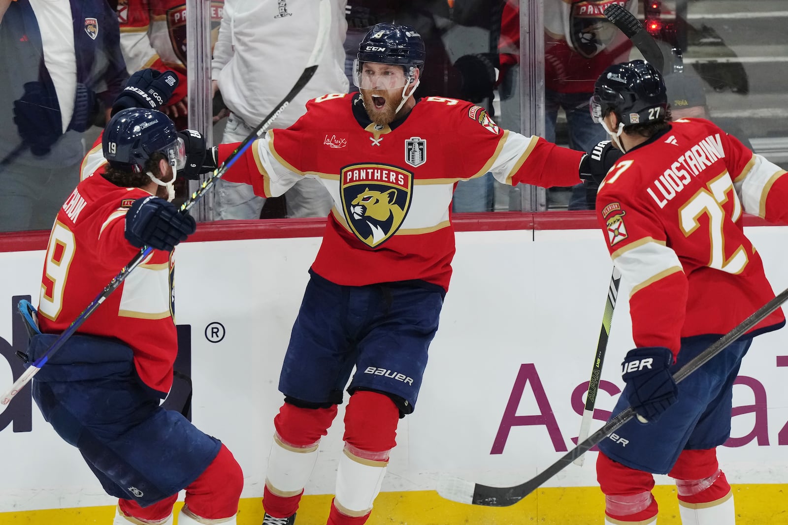 Florida Panthers' Sam Bennett (9) celebrates his goal against the Edmonton Oilers with Matthew Tkachuk (19) and Eetu Luostarinen (27) during the second period in Game 3 of the NHL hockey Stanley Cup finals in Sunrise, Fla., Monday, June 9, 2025. (Nathan Denette/The Canadian Press via AP)