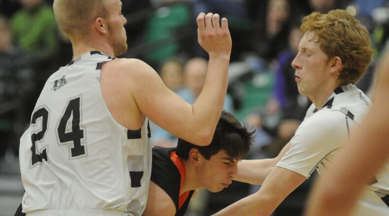 Greenon’s Trevor Anderson (left) and Austin Swope (right) double-team a Versailles player. Greenon played top-seeded Versailles in a boys high school basketball D-II sectional semifinal at Northmont on Tuesday, Feb. 28, 2017. MARC PENDLETON / STAFF