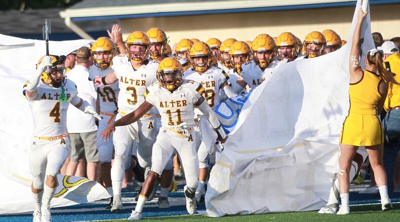 Jack McKelvey (left, 4), Kale Steneman (3) and Marcael O’Neal (11) lead Alter onto the field. Third-ranked Alter (D-III) defeated host Fairmont 21-7 in a Week 1 high school football game. MARC PENDLETON / STAFF