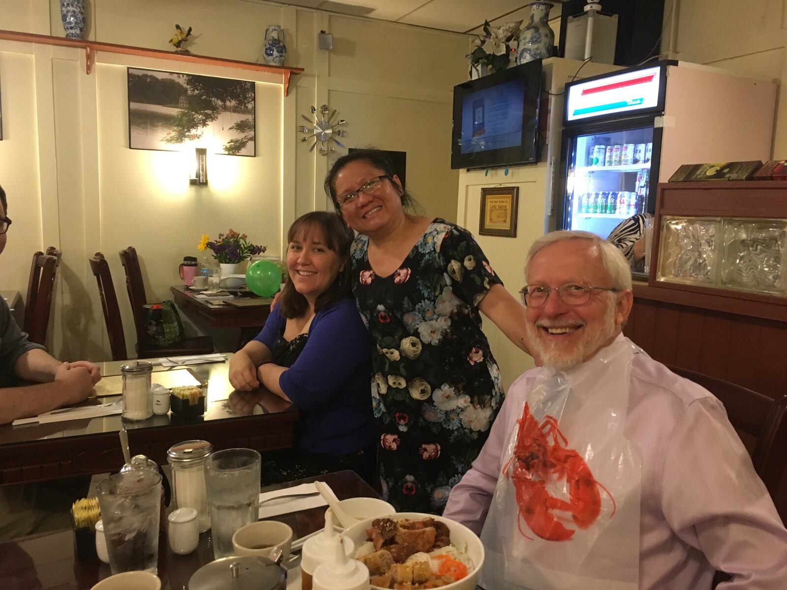 Little Saigon Restaurant co-owner, Thauh Do “T.D.” Tran, visits with some of the restaurant's most regular customers.