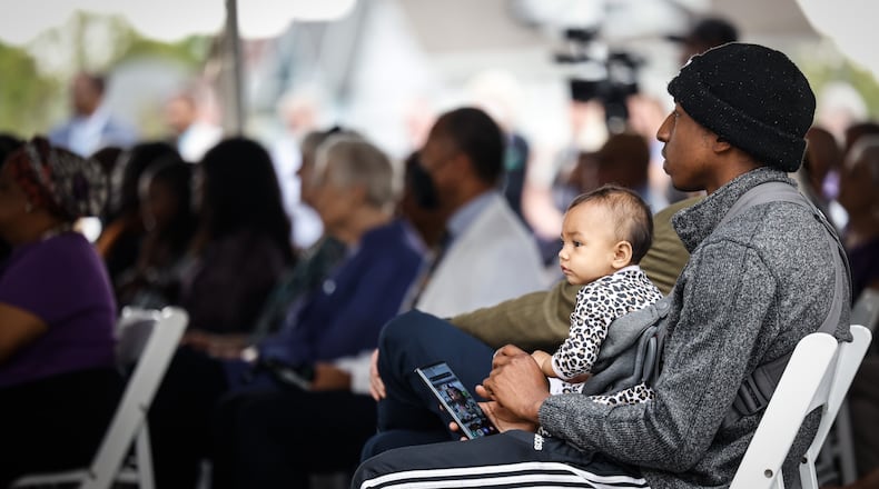 FILE - Jamaal McFarlane and his daughter, Marlea Castelanos, listen to the grand opening speakers at the Edgemont Five Rivers Health Center ribbon cutting on May 11, 2022. JIM NOELKER/STAFF