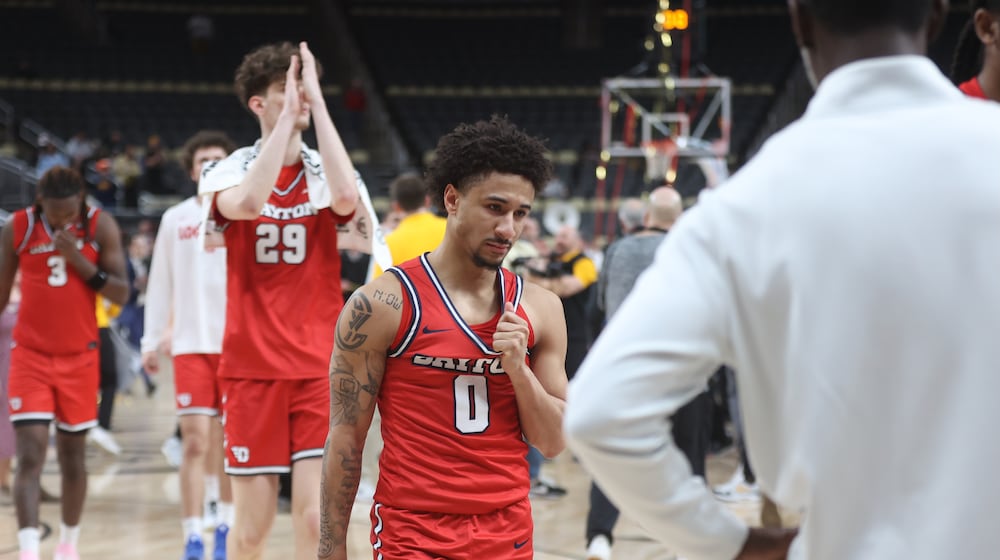 Dayton players, including Javon Bennett, center, leave the court after a loss to Virginia Commonwealth in the Atlantic 10 Conference championship game on Sunday, March 15, 2026, at PPG Paints Arena in Pittsburgh. David Jablonski/Staff