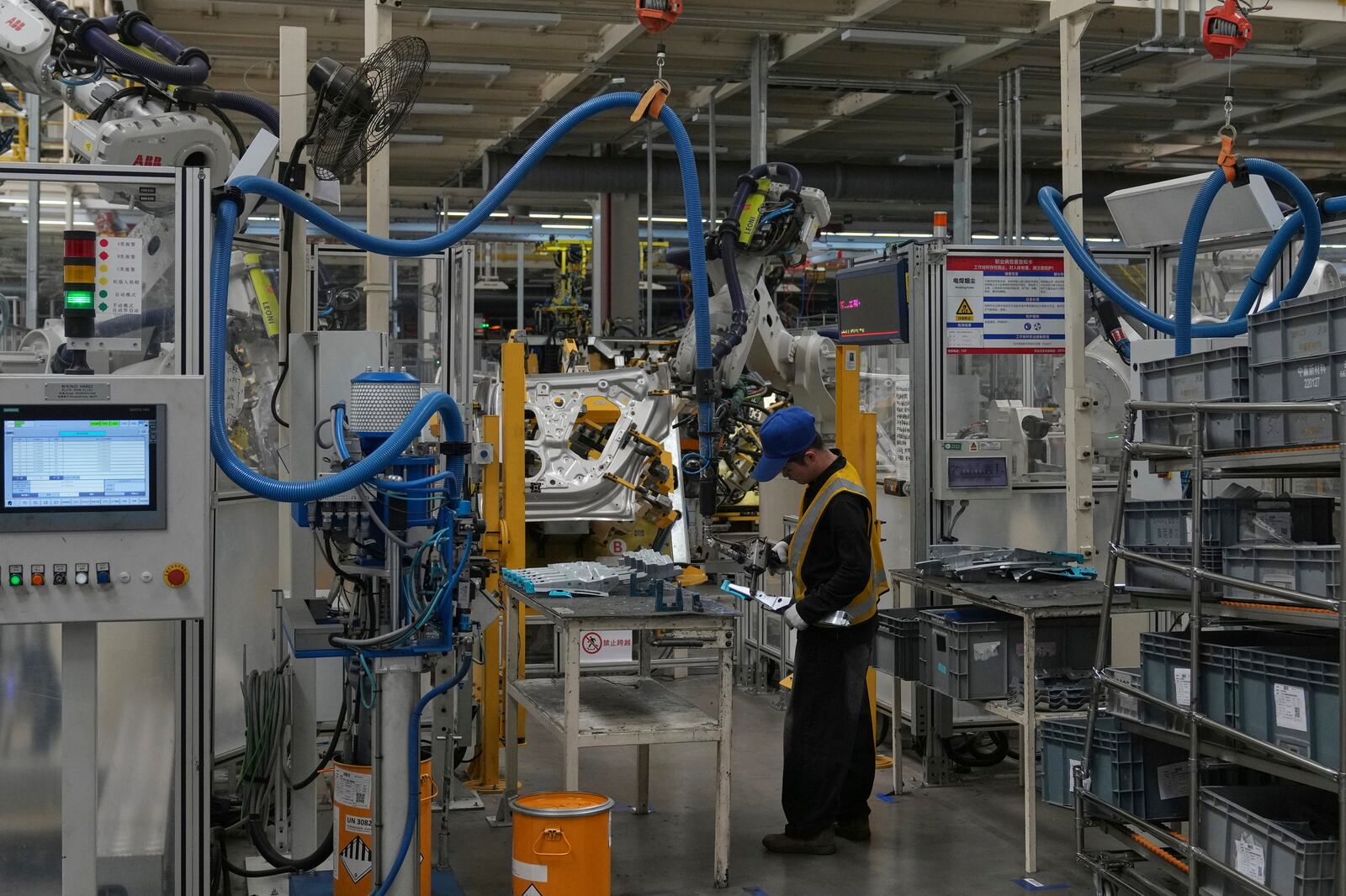 Workers assemble door panel parts of the Zeekr 001 EV models at the Chinese automaker Zeekr assembly plant in east China's Zhejiang Province on April 16, 2025. (AP Photo/Andy Wong)