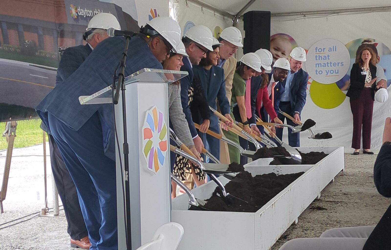 Dayton Children's officials and other community members and leaders hold a ceremonial dig to kick of the construction of a new pediatric urgent care coming to West Dayton. SAM WILDOW/STAFF