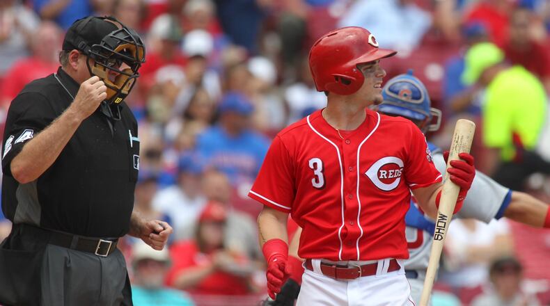 The Reds’ Scooter Gennett strikes out against the Cubs on Sunday, June 24, 2018, at Great American Ball Park in Cincinnati.