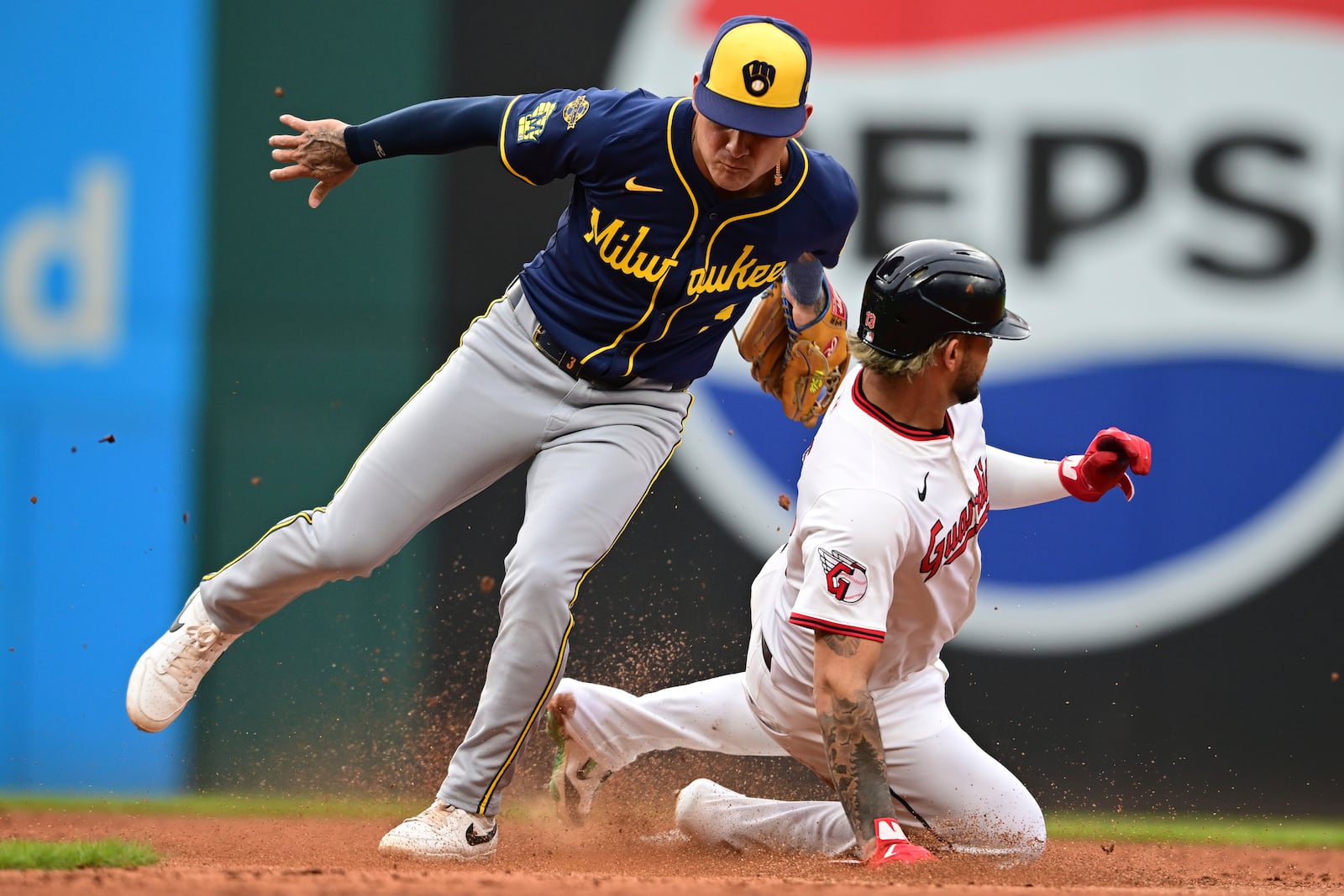 Milwaukee Brewers second basemen Brice Turang tags out Cleveland Guardians' Gabriel Arias at second base after a field steal attempt during the fifth inning of a baseball game, Tuesday May 13, 2025, in Cleveland. (AP Photo/David Dermer)