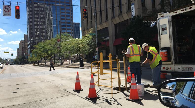 A city of Dayton work crew is shown on the job. STAFF/CORNELIUS FROLIK