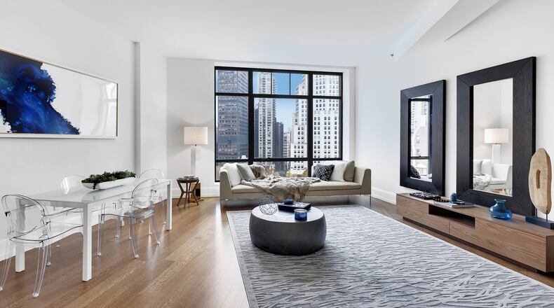 Inexpensive oversized mirrors help frame this living room space. (Handout/TNS)