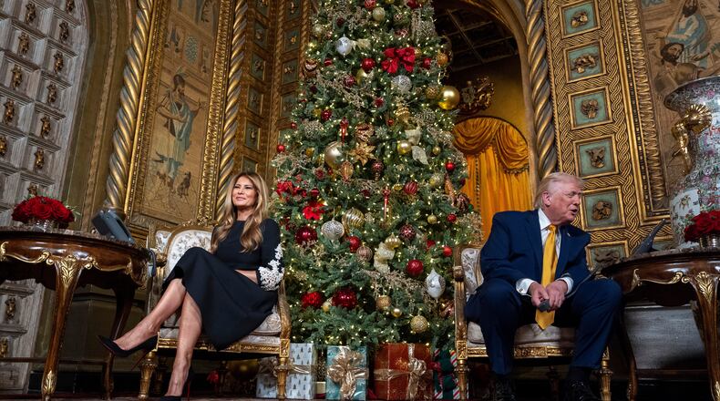 President Donald Trump, speaks accompanied by first lady Melania Trump, during a NORAD, North American Aerospace Defense Command, Tracks Santa Operation call at his Mar-a-Lago club, Wednesday, Dec. 24, 2025, in Palm Beach, Fla. (AP Photo/Alex Brandon)