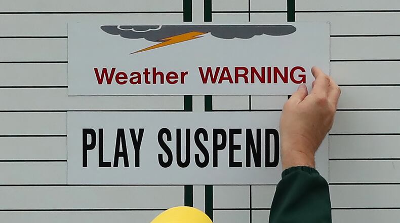 A weather warning is posted at the 17th tee area suspending play and closing the grounds during practice for the Masters at Augusta National Golf Club on Wednesday. (Curtis Compton/ccompton@ajc.com)