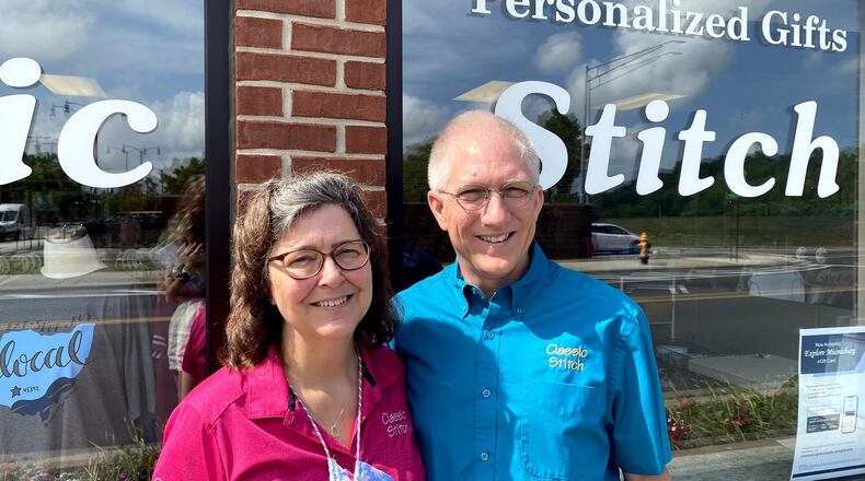 Shop owners Julie and Steve Grice standing outside of their Miamisburg store Classic Stitch.