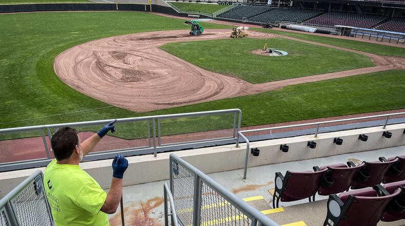 Kenny York paints the walkway in the stands at Day Air Ballpark Wednesday May 5, 2021. JIM NOELKER/STAFF