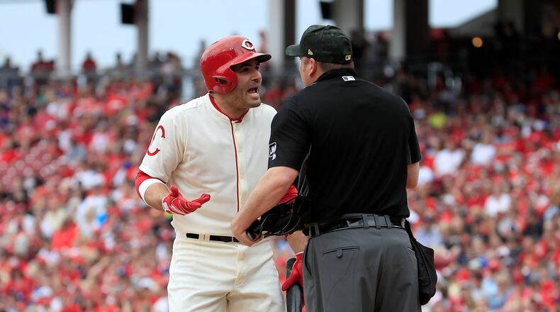 CINCINNATI, OHIO - MAY 19: Joey Votto #19 of the Cincinnati Reds has words with home plate umpire Dan Bellino after striking out in the first inning against the Los Angeles Dodgers at Great American Ball Park on May 19, 2019 in Cincinnati, Ohio. (Photo by Andy Lyons/Getty Images)