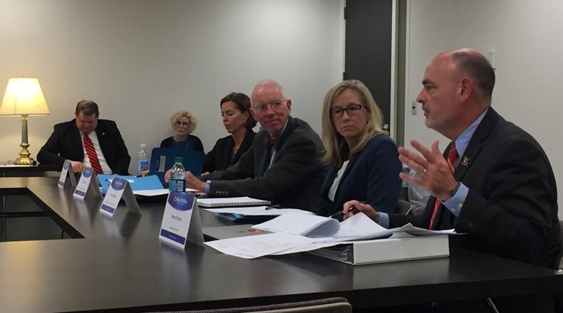 Brent Shock, assistant vice president of enrollment management and director of financial services at Miami University, right, talks about student loan debt collections at the Ohio Attorney General’s student loan advisory group meeting in Columbus in October.