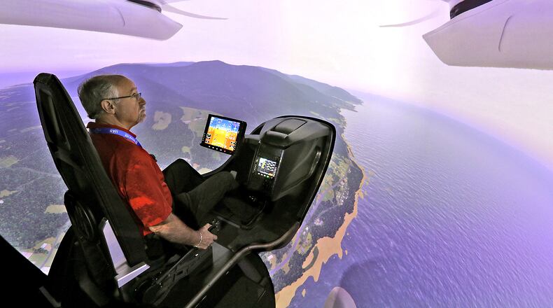 Joe Sciabica, from the Arctos company in Dayton, flies one of BETA Technologies flight simulators Tuesday, August 23, 2022 during the second day of the National Advanced Air Mobility Industry Forum at Springfield Beckley Municipal Airport. BILL LACKEY/STAFF