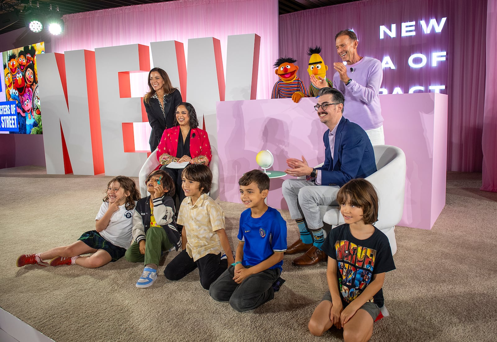 Children pose for photos with Sesame Street's Bert and Ernie and others during the Elevate Prize Foundation's Catalyst Award, Wednesday, May 14, 2025, in Miami Beach, Fla. (AP Photo/Michael Laughlin)