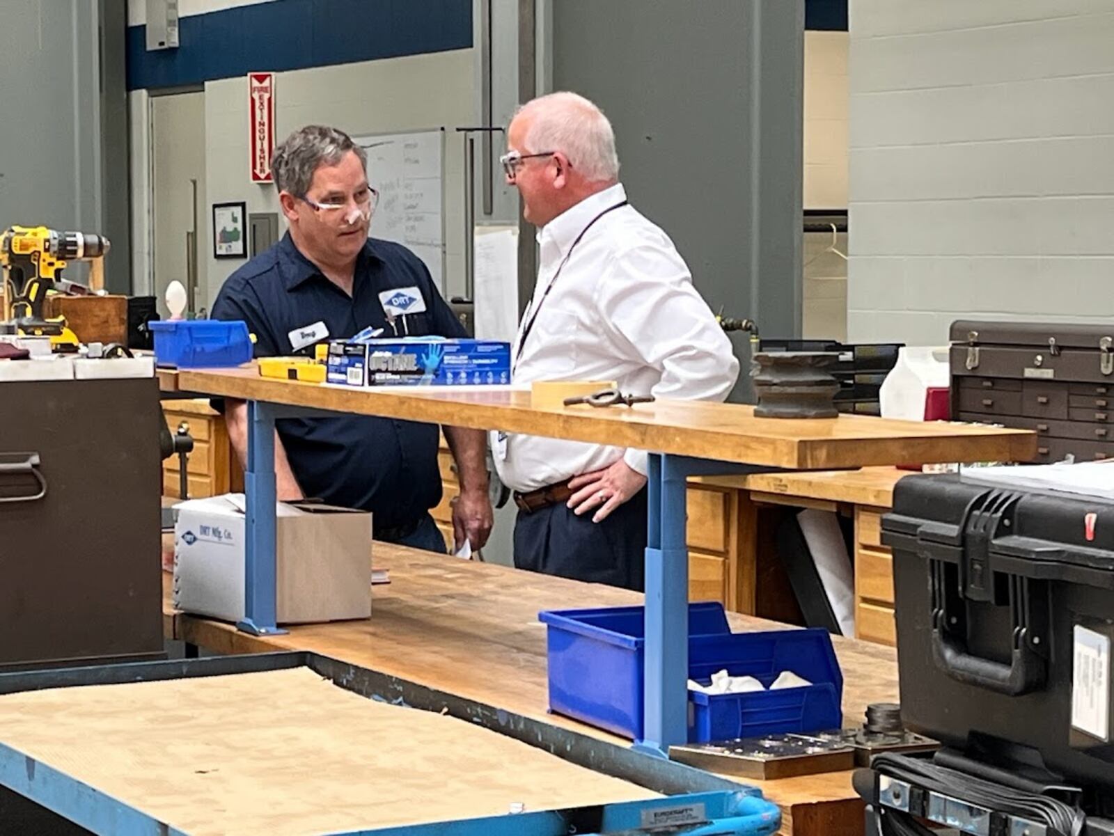 Rob Cohen, DRT chief executive (right), speaking with an employee at DRT's Dayton plant near the Dayton-Kettering municipal border on Greenmount Boulevard. THOMAS GNAU/STAFF