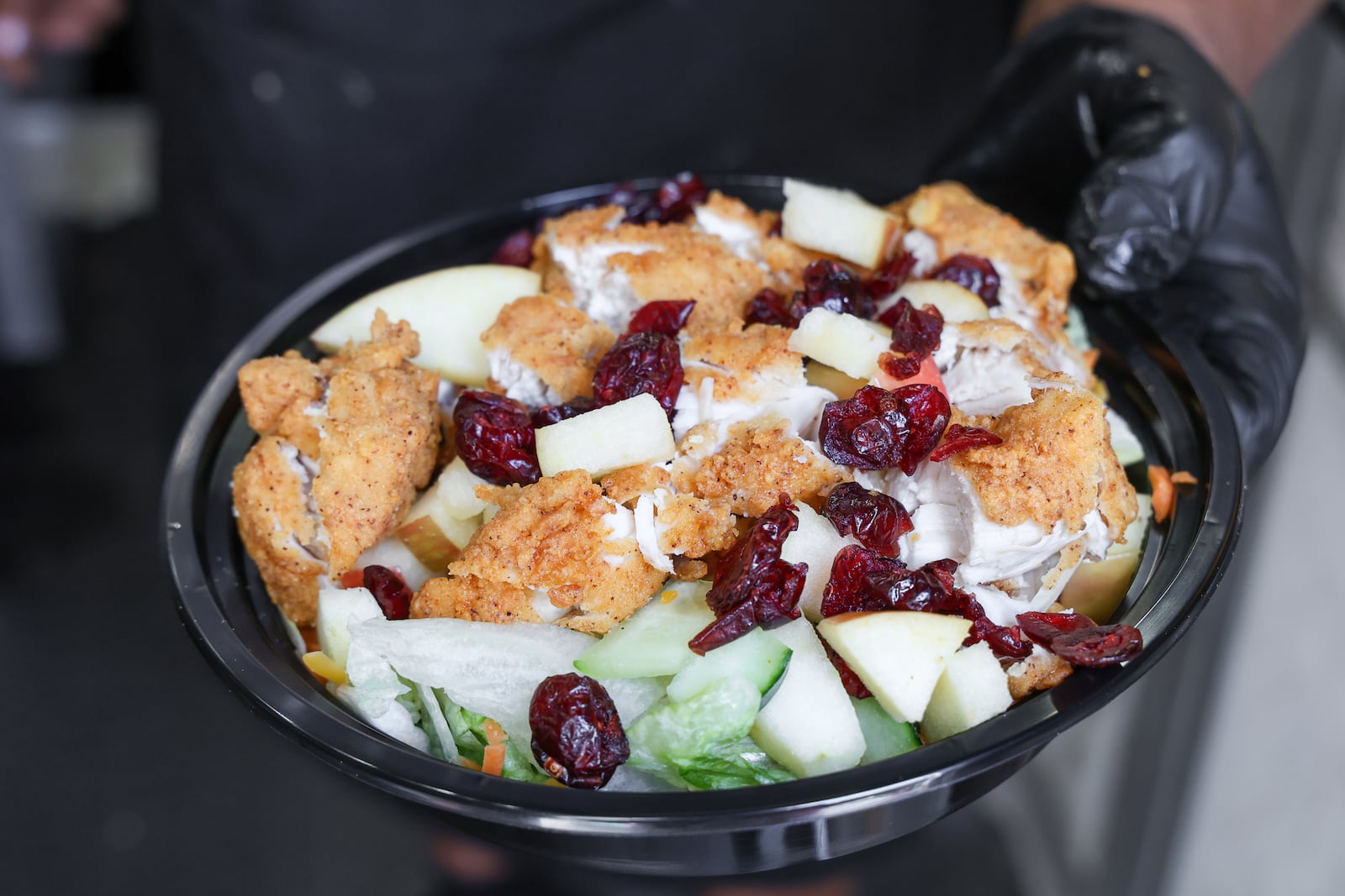 Guy Ansley holds a salad he made at Courtland's Mobile Grill on Tuesday. He is taking over a space at W. Social. BRYANT BILLING / STAFF