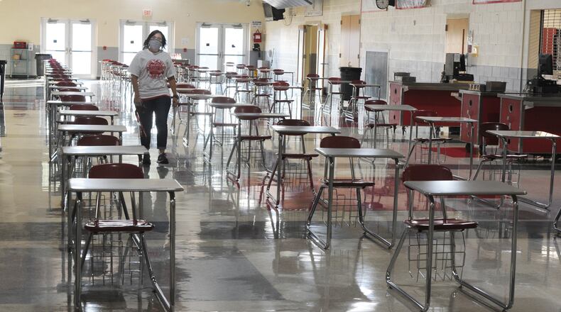 Stebbins High School Principal Tina Simpson, walks through the lunchroom with individual tables that were set up for social distancing. MARSHALL GORBY\STAFF