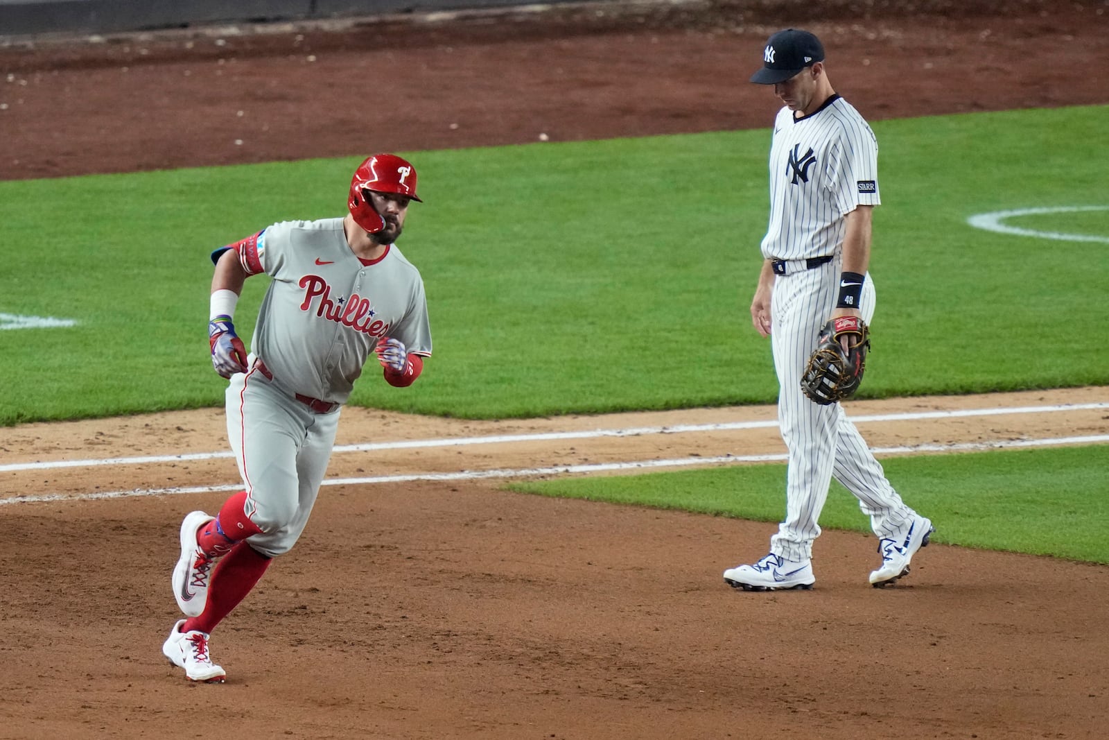 New York Yankees first base Paul Goldschmidt, right, reacts as Philadelphia Phillies' Kyle Schwarberruns the bases after hitting a two-run home run during the eighth inning of a baseball game Friday, July 25, 2025, in New York. (AP Photo/Frank Franklin II)