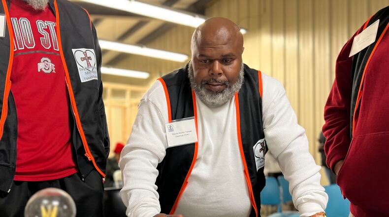 Maxies Morrell demonstrates his HVAC knowledge prior to the Dayton Urban Ministry's electrical/HVAC program graduation Saturday. AIMEE HANCOCK/STAFF