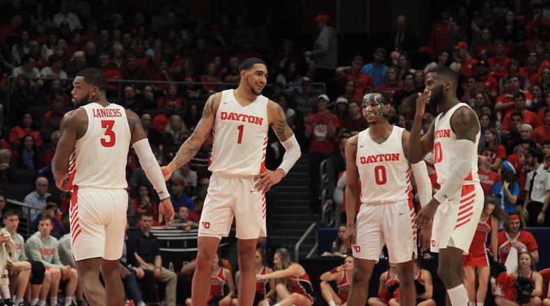 Dayton players watch a teammate shoot free throws against Duquesne on Saturday, Feb. 22, 2020, at UD Arena. David Jablonski/Staff