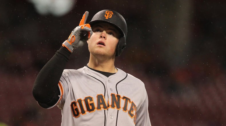 The Giants’ Christian Arroyo crosses home plate on Friday after hitting a home run against the Reds’ Bronson Arroyo. David Jablonski/Staff