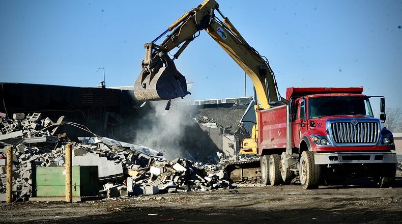 Plans for a vacant Fairborn shopping center being redeveloped include up to 140 apartments, along with a 600-unit indoor storage facility already in the works. The former Kroger has been demolished and crews are working on the former Kmart, which will house the indoor storage facility. MARSHALL GORBY \STAFF