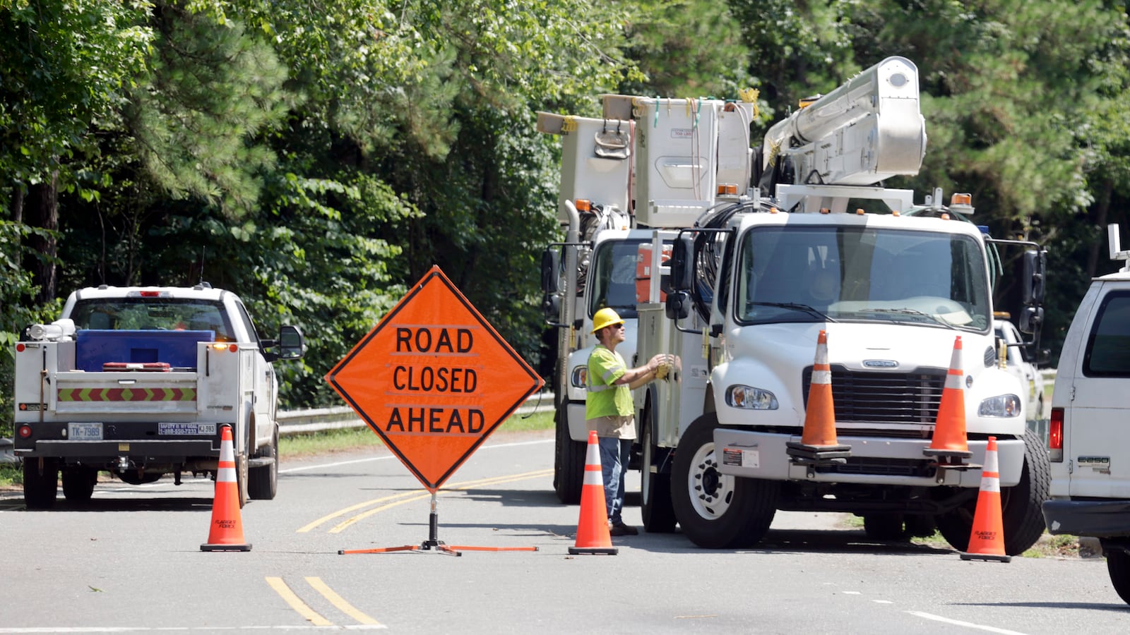 Utility crews work to restore lines that were knocked down on Estes Drive during tropical storm Chantal, Monday, July 7, 2025, in Chapel Hill, N.C. (AP Photo/Chris Seward)